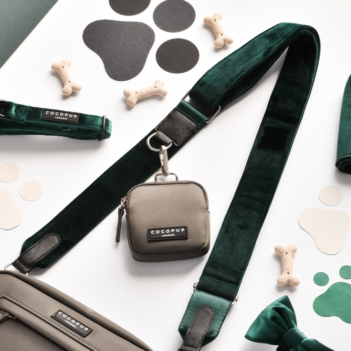 Forest green leash, treat pouch, bone-shaped treats, and Cocopup London dog walking bag with matching velvet strap.