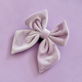Lilac velvet sailor bow tie from Cocopup London on a lavender background.