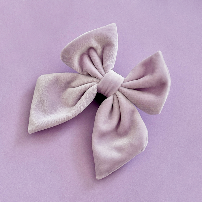 Lilac velvet sailor bow tie from Cocopup London on a lavender background.