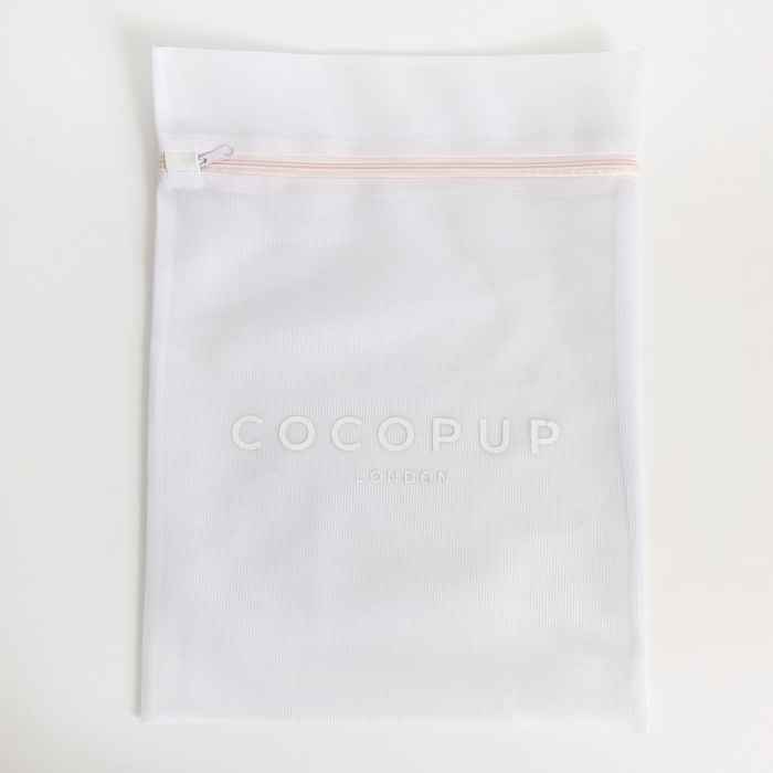 White mesh Cocopup London washing machine bag with zipper closure.