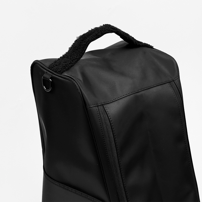 Black Cocopup London Welly Boot Bag with textured handle and visible zipper, shown close-up against a white background.