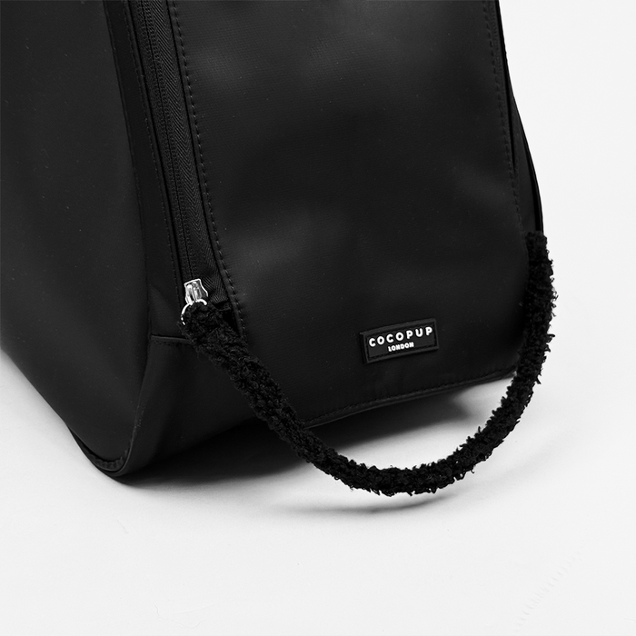 Black Welly Boot Bag by Cocopup London with textured handle and visible label on a white background.